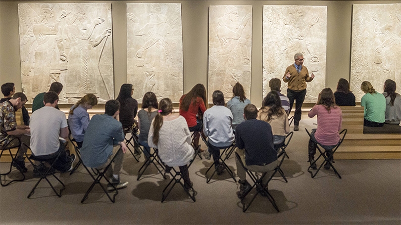 Professor Steven Kangas talks with his class about the ancient Assyrian reliefs at the Hood Museum of Art
